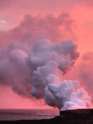 Steam from the lava flow of Kilauea flowing into the ocean at sunset on the Big Island of Hawaii.