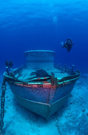 A diver checks out a wreck off the coast of the Cocos Islands.