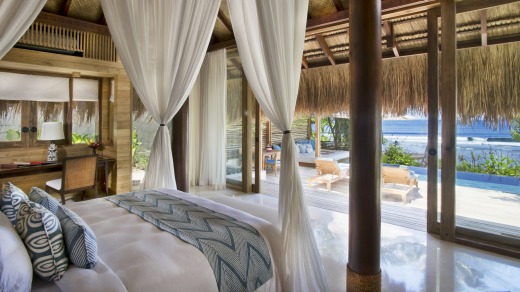 A bedroom with a pool view at the Nihiwatu resort.
