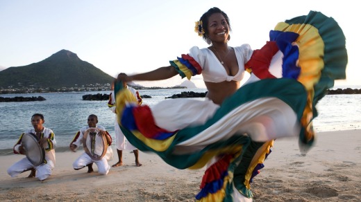 Swirling colours: A woman performs the sega, the national dance of Mauritius.