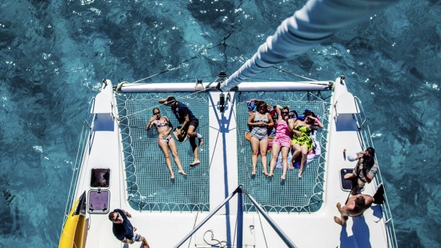 Clear blue waters: Relaxing on a catamaran.