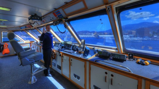 Captain Nathan Clark in the bridge of Coral Expeditions I.