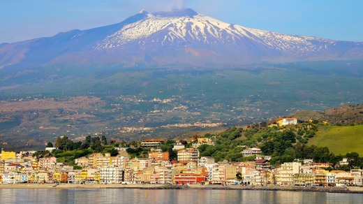 View of Mt Etna over Taormina in Sicily.