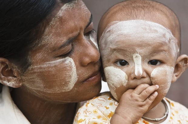 THANAKA: Many Myanmar women and children apply a fragrant creamy paste known as thanaka to their faces in decorative ...
