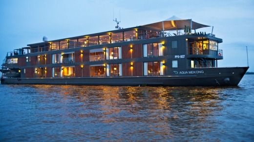 The cruise ship Aqua Mekong idles along the traditional river transport system of Cambodia.