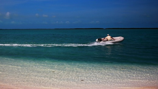 Catamaran captain Miguel Fiallo Granda leaves a deserted island in a dinghy.