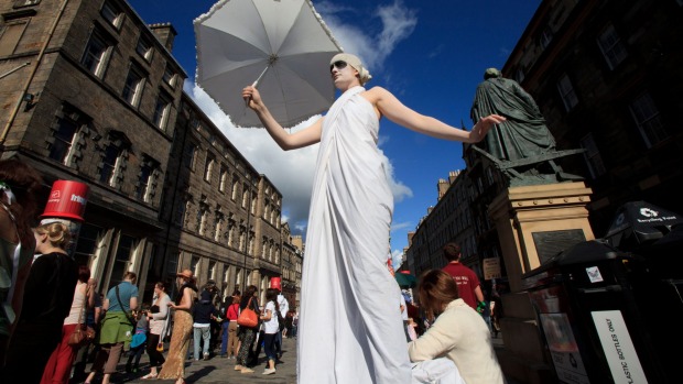Fringe performers promote their shows on Edinburgh's Royal Mile.