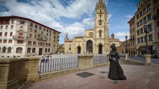 Cathedral and statue of woman in Oviedo, Italy.