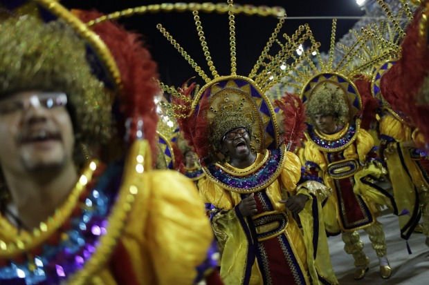 A performer from Estacio de Sa samba school sings as he parades during the Carnival celebrations at the Sambadrome in ...