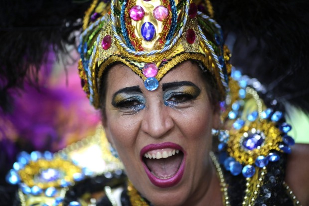A patient from the Nise de Silveira mental health institute dances in costume during the institute's carnival parade, ...