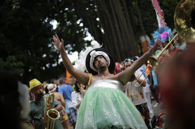 A patient from the Nise de Silveira mental health institute dances in costume during the institute's carnival parade, ...