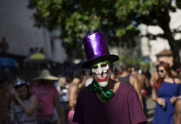 A reveller wearing a mask depicting the "The Joker" comic character, attends the "Carmelitas" block party during ...