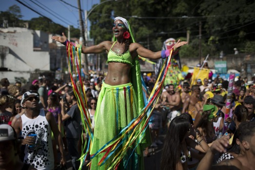 A reveler performs at the "Carmelitas" block party during Carnival celebrations in Rio de Janeiro, Brazil, Friday, Feb. ...