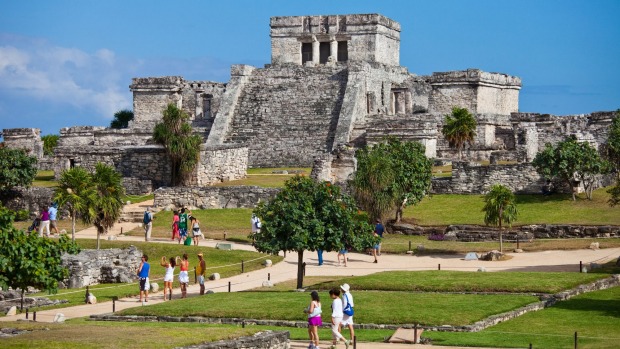 Mayan ruins tower over the green countryside at Tulum.