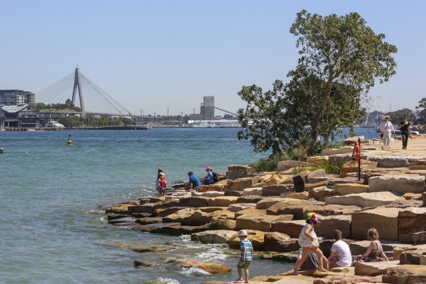 People enjoying the warm spring weather at Barangaroo Park.