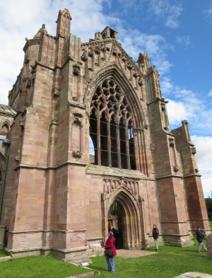 The rose-coloured exterior of Melrose Abbey.