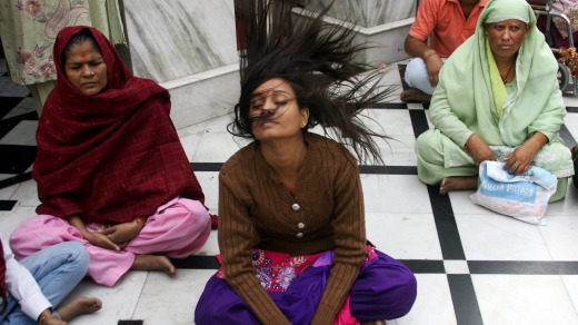 A woman offers Garland to the Goddess Kaali on the last day of Hindu festival Navrati in Kali devi temple . Navratri ...