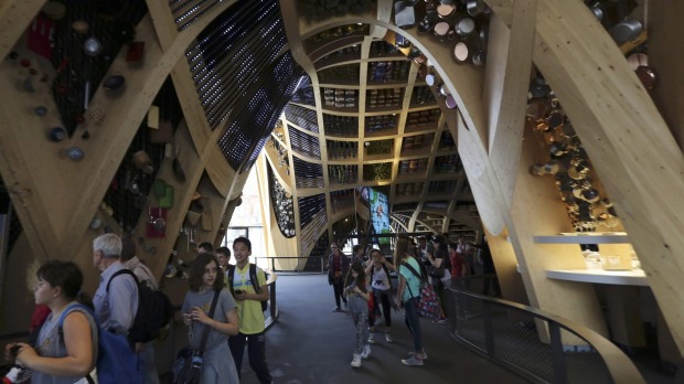 People visit the France pavilion at the Expo 2015 in Milan, northern Italy. Officials are counting on some 20 million ...