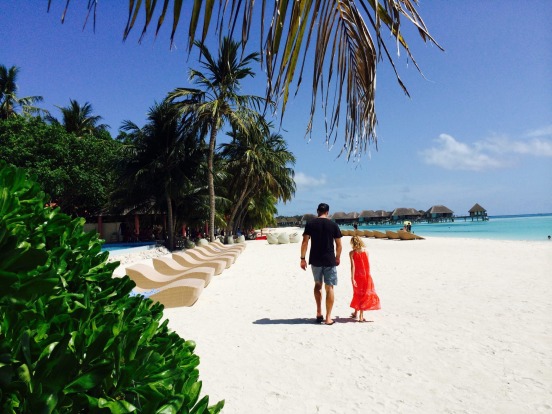 A father-daughter walk on the beach at Club Med Kani.