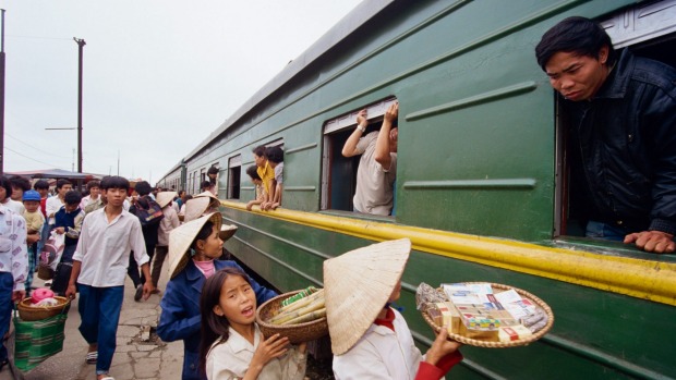 On the move: Vendors offer their wares to passengers at Nha Trang station, Vietnam.