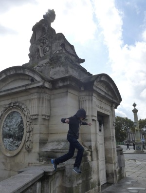 A teenager tries parkour in Paris.