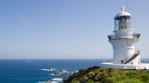 Three heritage cottages sit below the lighthouse at Seal Rocks.