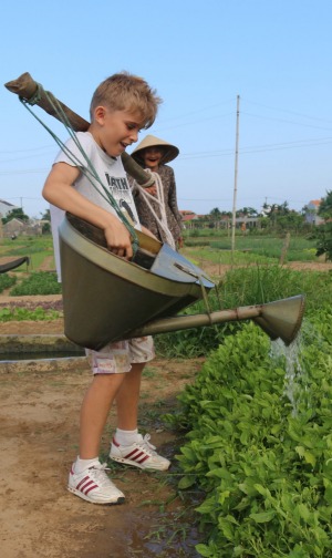 When in Rome... The children try their hand at tending the crops.