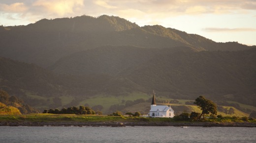 The historic Anglican Christ Church cuts a lonely figure on its promontory in Papatea Bay.