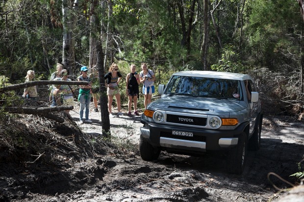 Receiving instruction at the practice grounds before driving up a steep hill.