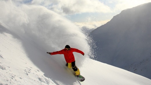 Fresh powder lures a snowboarder at The Remarkables ski field in Queenstown.