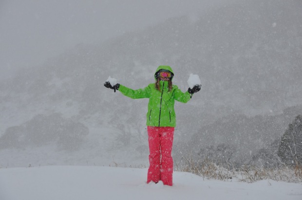 A woman makes snowballs at Perisher over the weekend.
