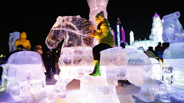 A girl rides a slide at the China Ice and Snow World on the eve of the opening ceremony of the Harbin International Ice ...