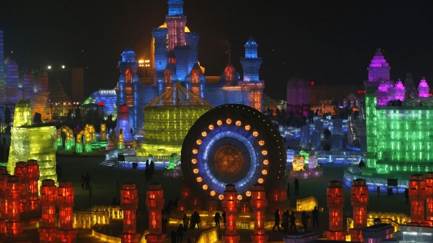 Ice sculptures are illuminated by coloured lights.