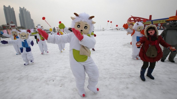 Dancers in costumes to celebrate commencement of the 16th Harbin International Ice and Snow Sculpture Festival. 2015 is ...