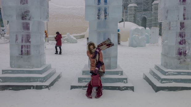 A woman visits the China Ice and Snow World on the eve of the opening ceremony of the Harbin International Ice and Snow ...