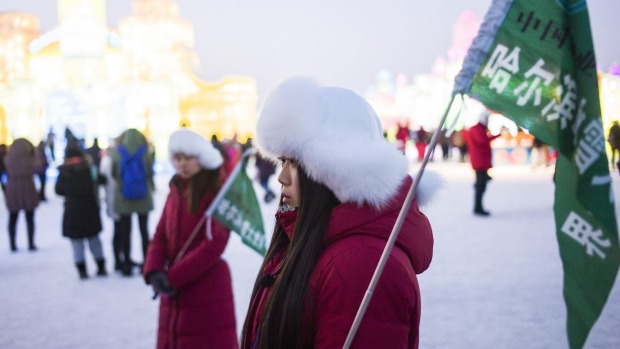 Guides wait for visitors during the Harbin International Ice and Snow Festival in Harbin, northeast China's Heilongjiang ...