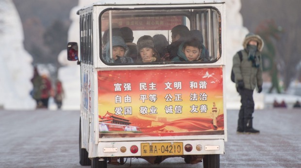 Children ride on a miniature bus during the Harbin International Ice and Snow Festival in Harbin, northeast China's ...