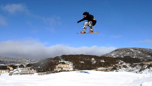 Safety first: A snowboarder gets some air over a jump.