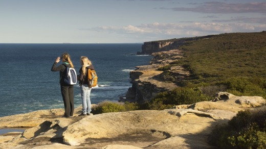 Hikers look towards the sea along the Royal National Park's coastal walk.