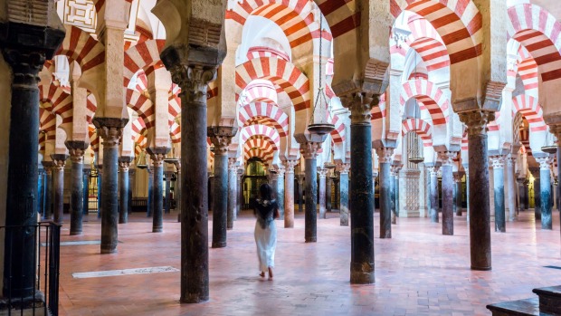 Woman walking inside the Mezquita of Cordoba.