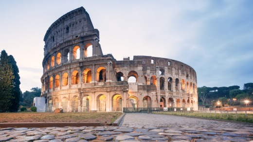 Landmark: The Colosseum in Rome at sunrise.