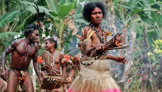 Women in traditional dress performing a Small Nambas ritual fire dance.