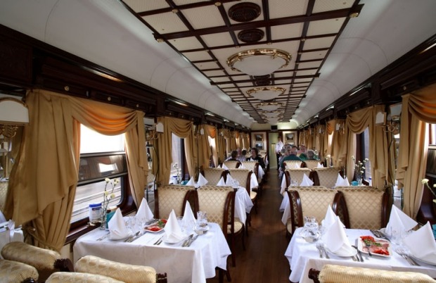 Dinner service in the Restaurant Car on a Golden Eagle luxury train.