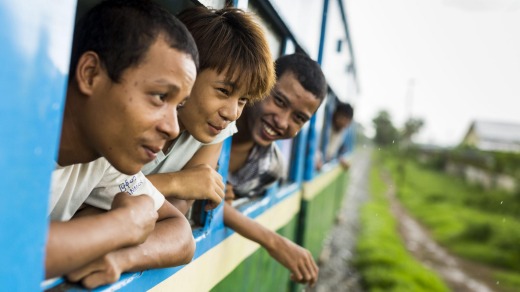 Passengers lean out of the windows of the Yangon Circular Train.