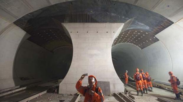 THE LONGEST RAILWAY TUNNEL IN THE WORLD: A journalist takes a picture of the 57km railway tunnel under construction in ...
