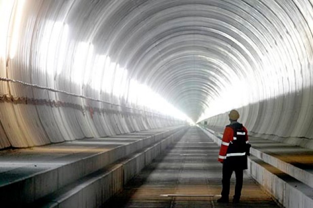 THE LONGEST RAILWAY TUNNEL IN THE WORLD: A visitor stands at the Erstfeld-Amsteg section of the NEAT Gotthard Base ...