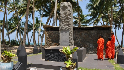 Trio's tribute: Monks visit the memorial to Sri Lanka's worst rail disaster.