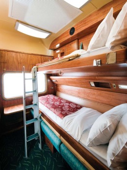 A gold class cabin on board the Indian Pacific after the sofa has been transformed into bunk beds.