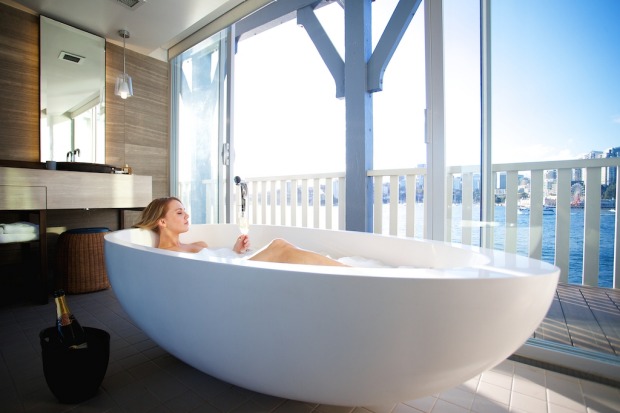 Giving ferry commuters a thrill: bathe with the blinds open in the Harbour View Balcony Suite.