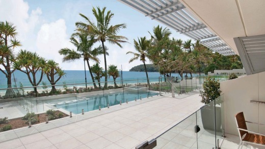 A view of the swimming pool and beyond from Fairshore Beachfront Apartments at Noosa.